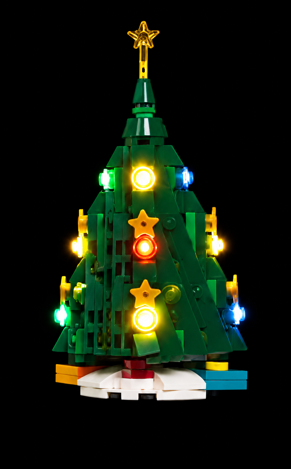Christmas tree from LEGO® Holiday Main Street 10308 with enhanced lighting against a black background