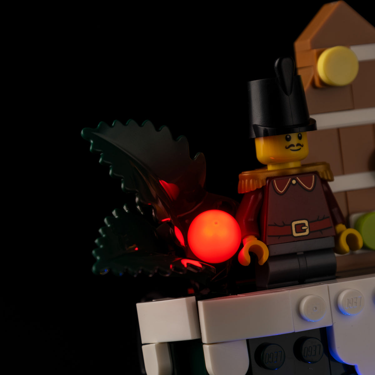 Real red berry light among holly beside the LEGO® Nutcracker minifigure on Christmas Stocking 40958.