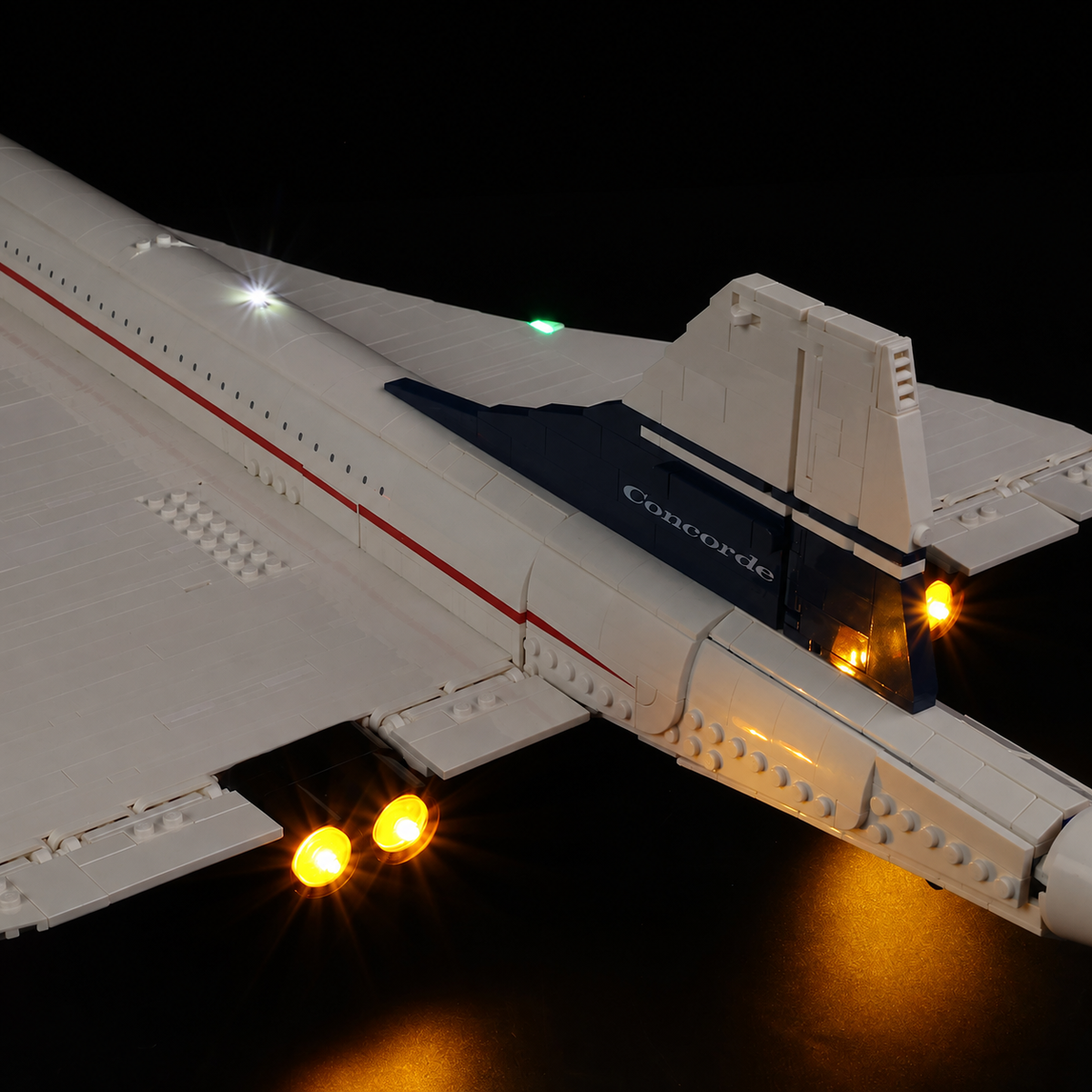Close view of four warm amber Game of Bricks lights in the LEGO Concorde engine outlets.