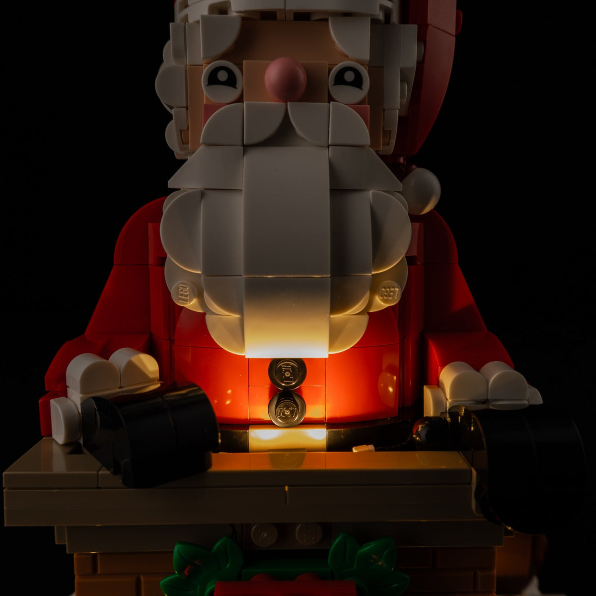 Close product photograph of the actual warm light under Santa’s beard and red coat in the LEGO® 40874 light kit.