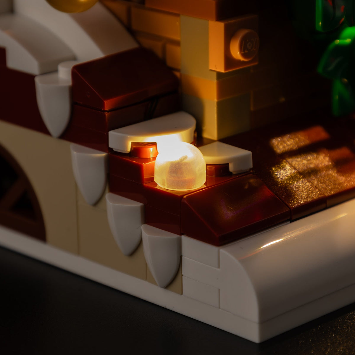 Real warm-white light points on the snow-covered ledges of LEGO® Santa’s Holiday Countdown 40874.