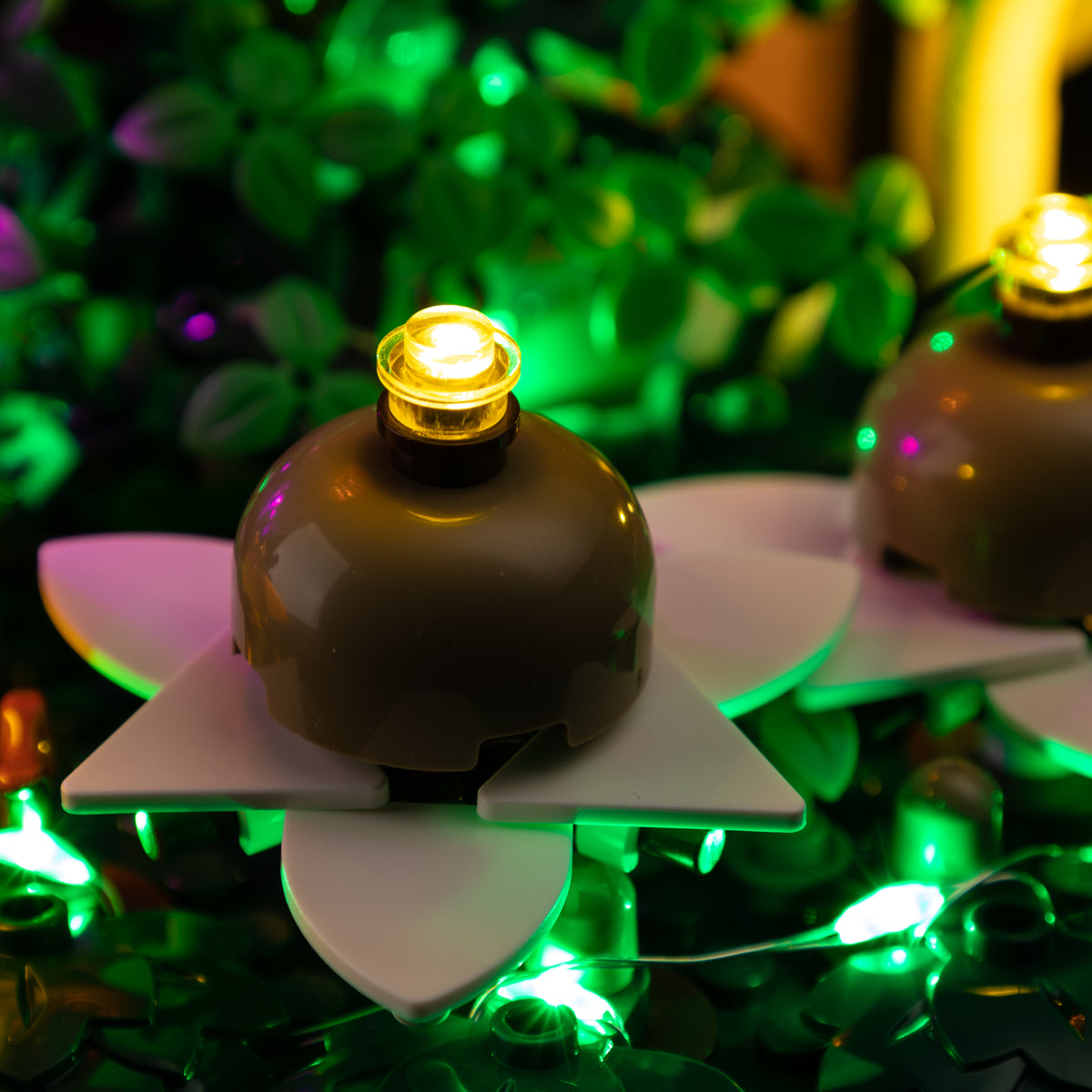 Small yellow light points in the earthstar centres above the white LEGO petal-like pieces.