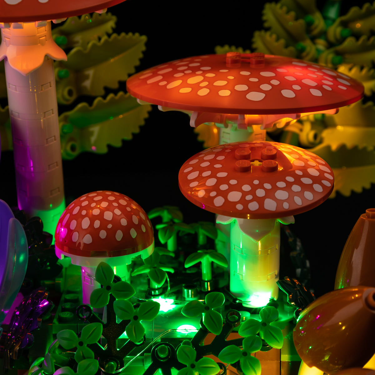 Real kit lighting under the spotted red caps and through the stems of LEGO Woodland Mushrooms.