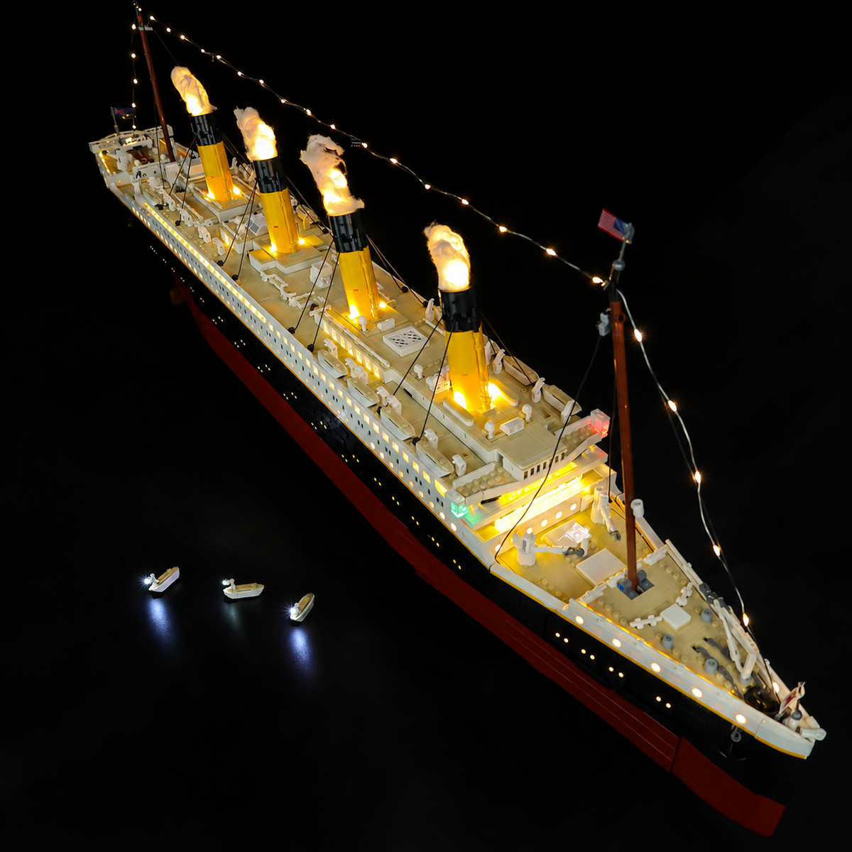 An elevated view along the illuminated decks and four funnels of LEGO® Titanic 10294.