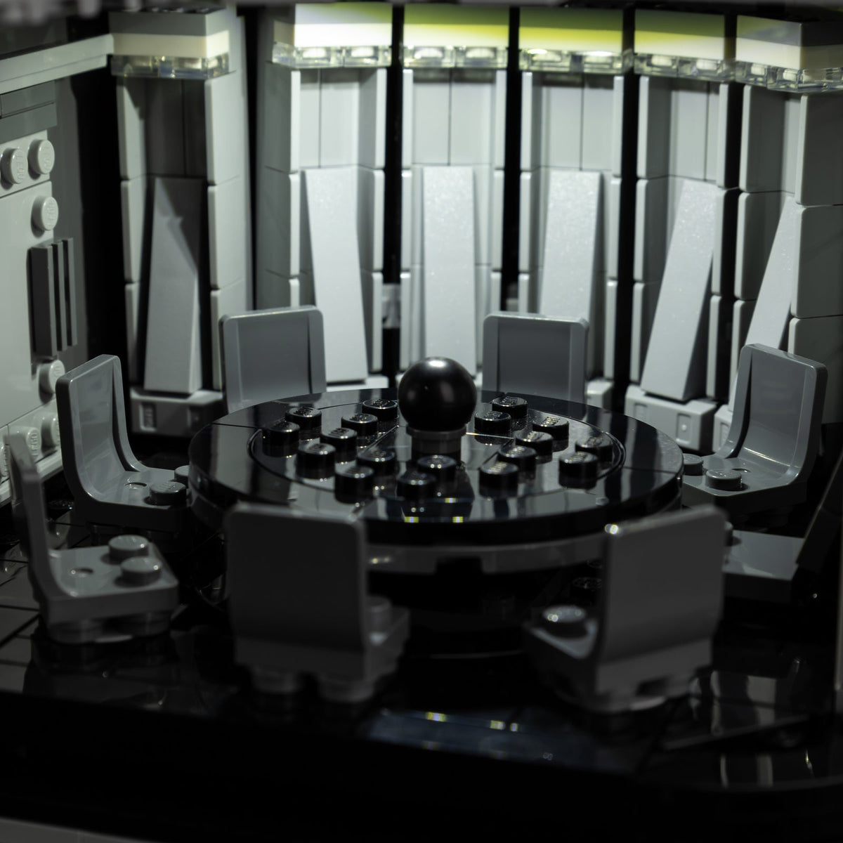 Death Star meeting room with white lighting above the circular table and chairs