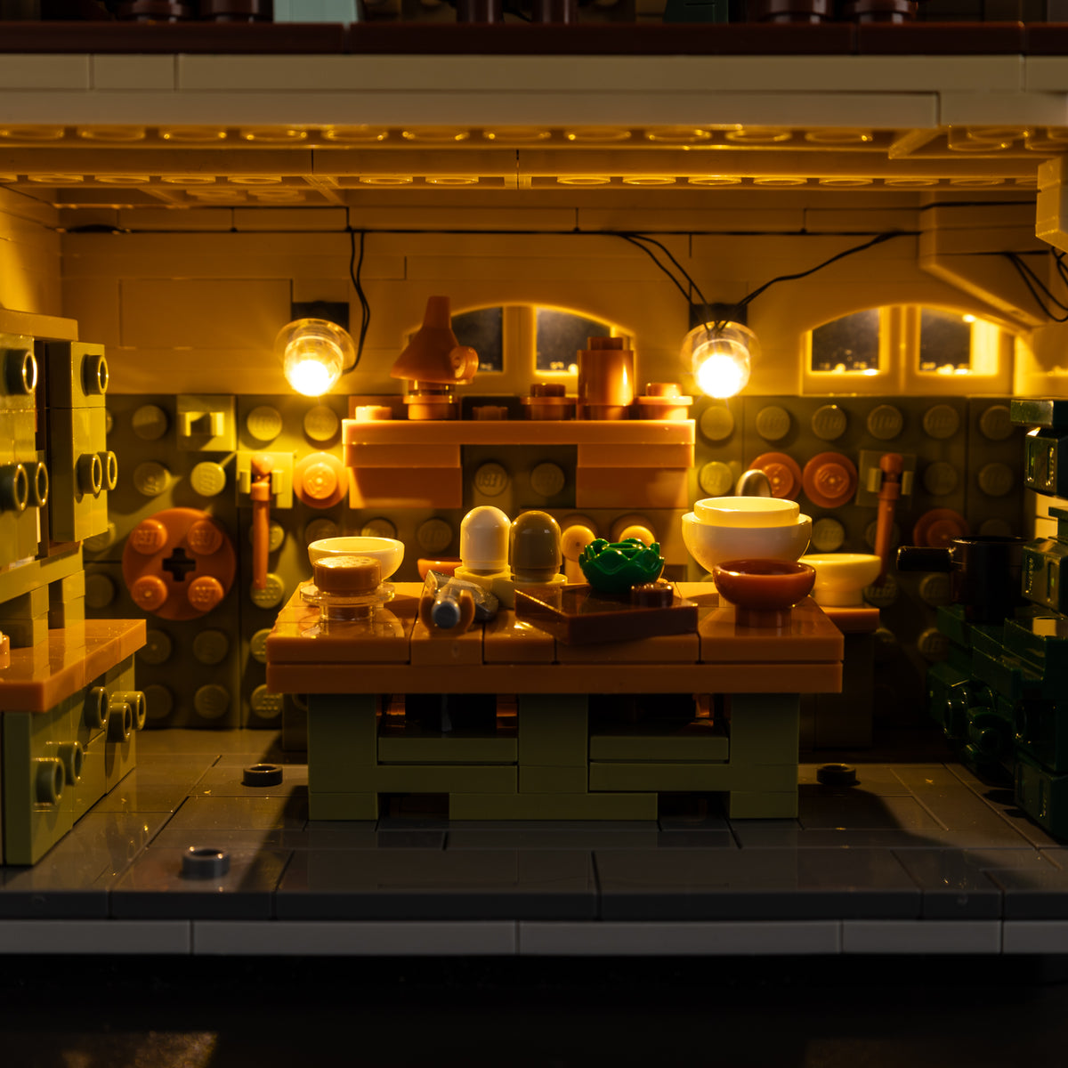 Lit kitchen with cookware, shelves and worktable