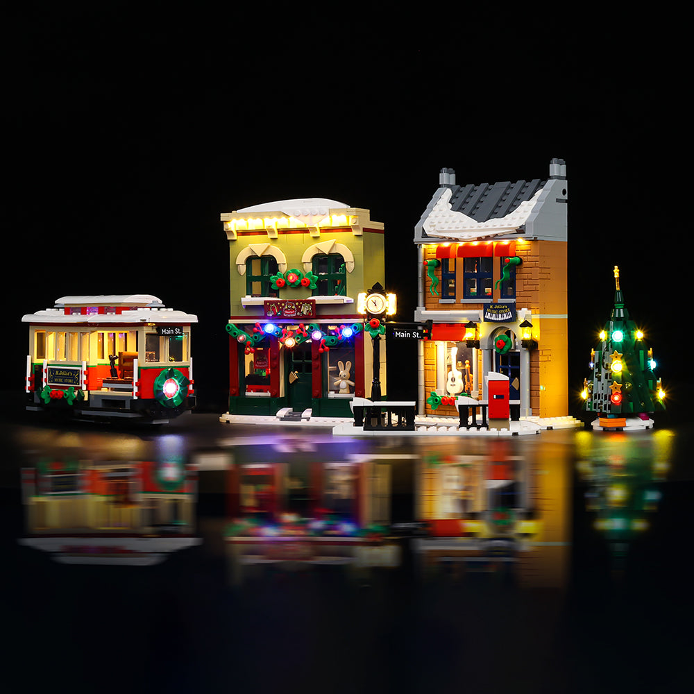 LEGO® Holiday Main Street 10308 shown with Enhanced Game of Bricks lighting across the shops, streetcar and tree.